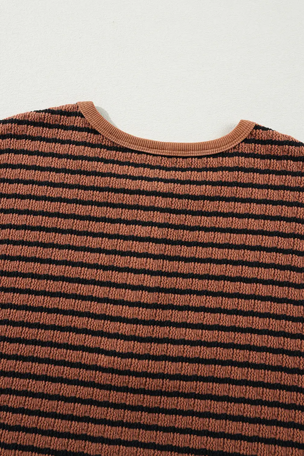 Relaxed fall layering beside warm wood and linen