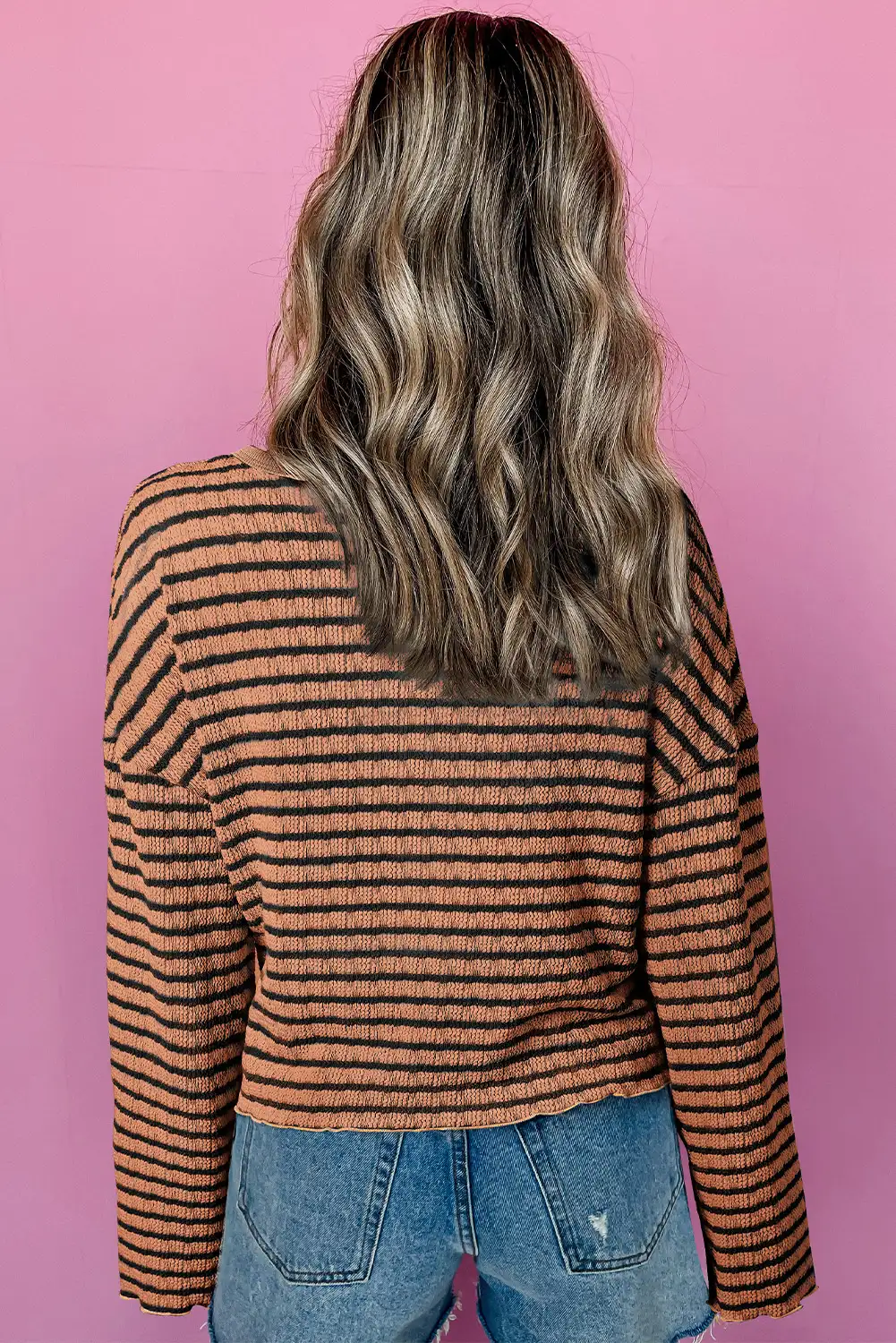 Close view of textured knit and frilly trim