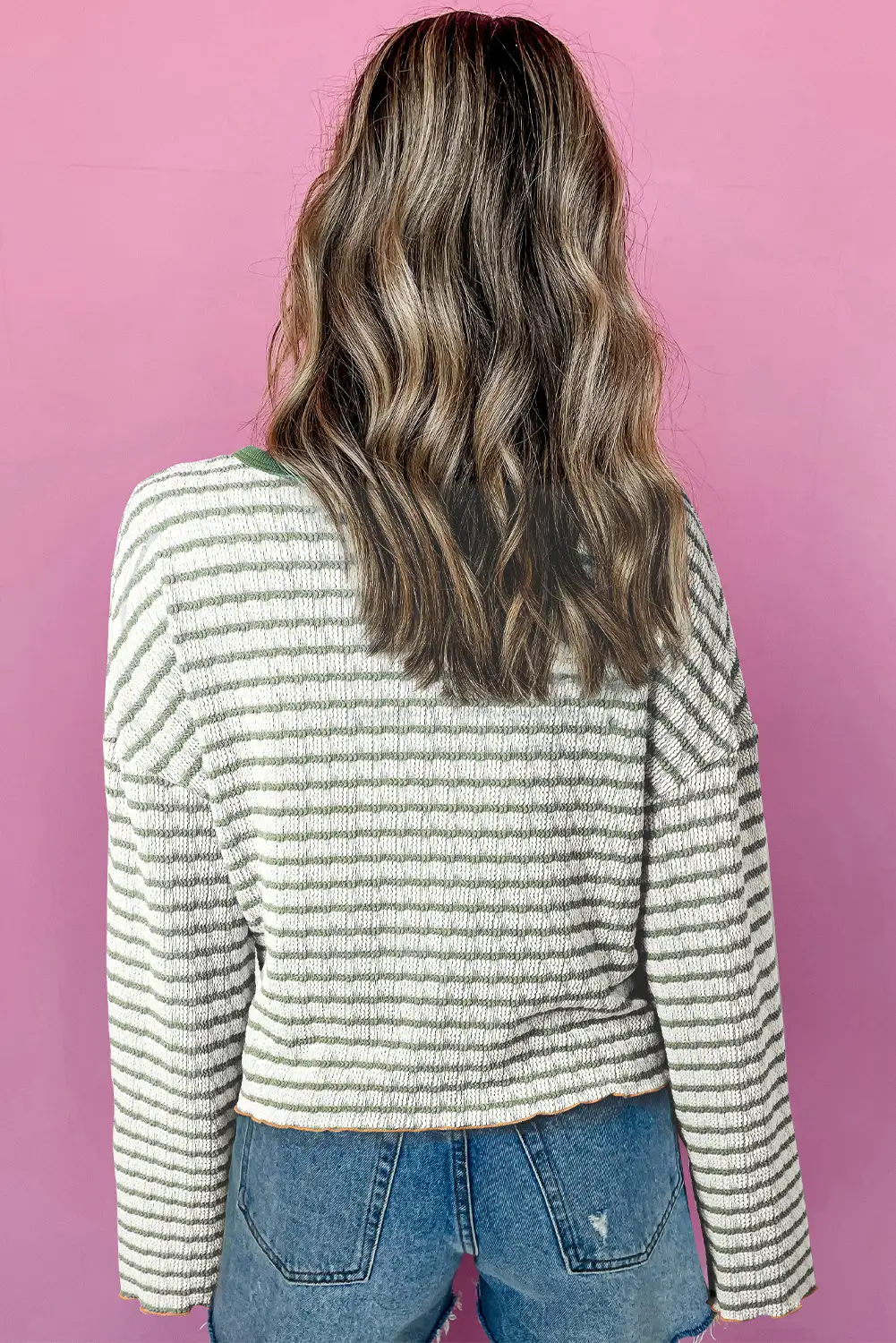 Close view of textured knit and button placket