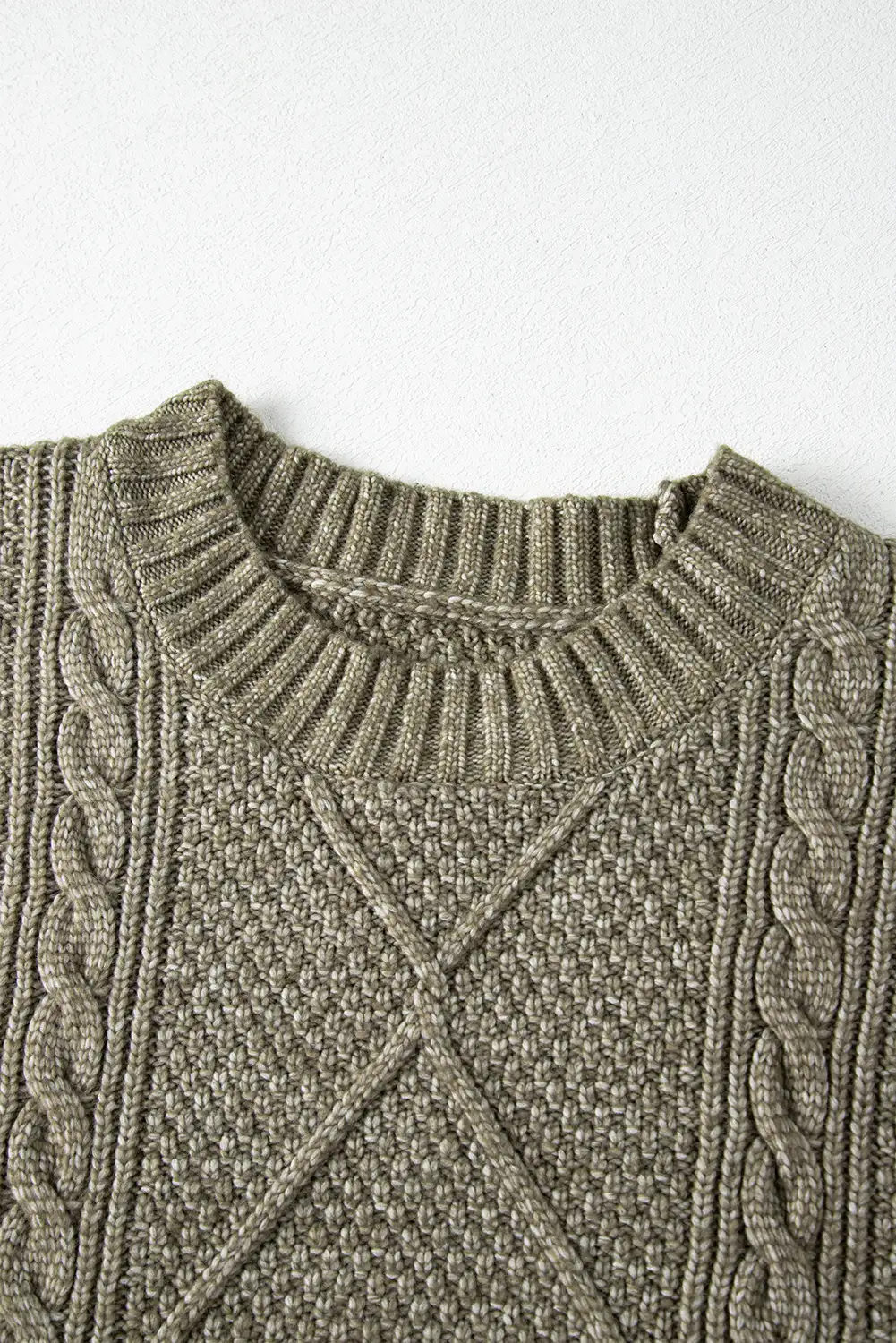 Sweater dress detail against a warm interior