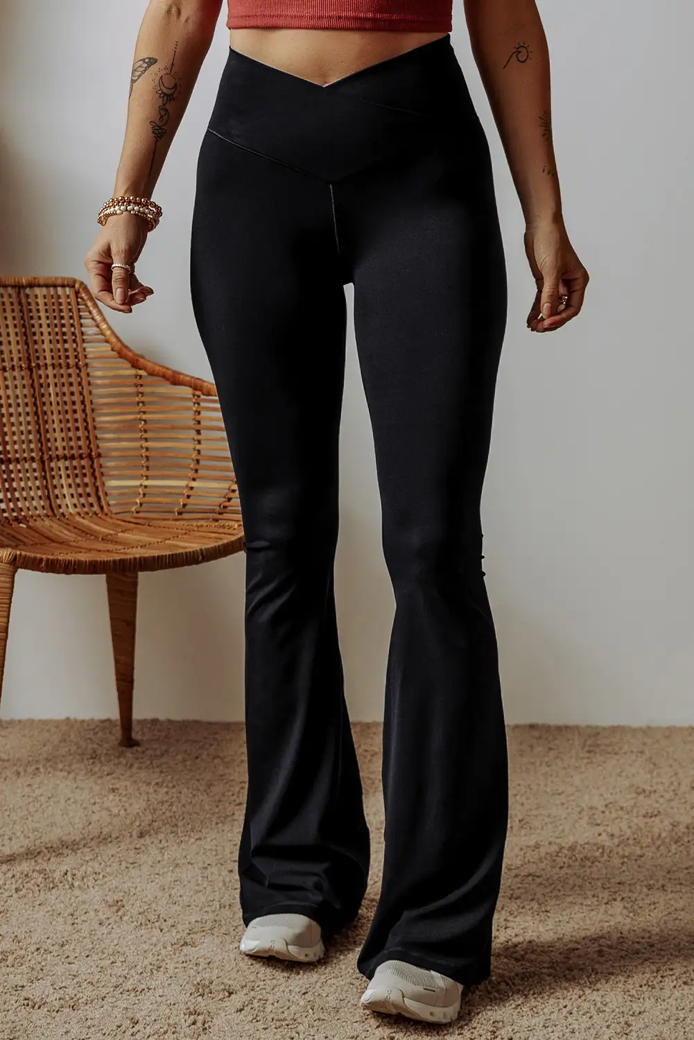 Relaxed daytime styling in black flared leggings with a simple top