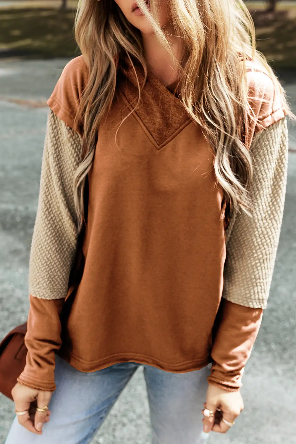Detail of the hood and neckline in soft window light