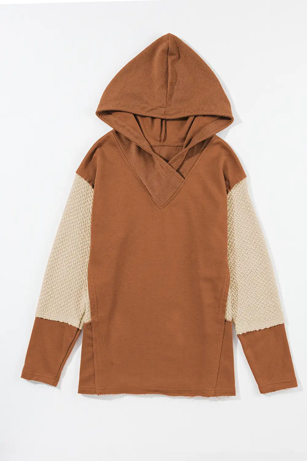 Side profile of the hoodie in a calm, sunlit setting